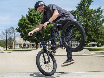 Rider performing a freestyle trick on the Symbol BMX bike at a skatepark. Rider performing a freestyle trick on the Symbol BMX bike at a skatepark.