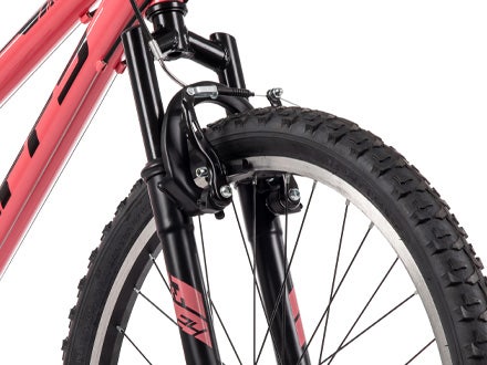 Front suspension fork on a Huffy Incline bike with black and pink accents, enhancing comfort and control on rugged trails. Front suspension fork on a Huffy Incline bike with black and pink accents, enhancing comfort and control on rugged trails.