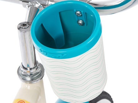 Teal and white handlebar cup holder on a cruiser bike, featuring a stylish wave pattern for holding drinks.