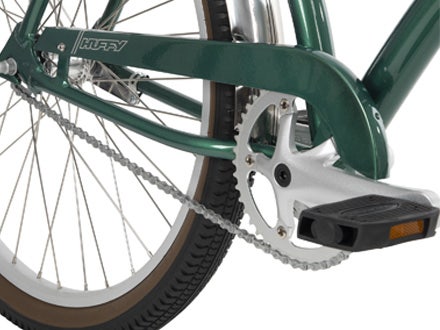 Close-up of chain guard and fenders on Huffy Sanford Cruiser Bike with a glossy green frame and polished silver accents Close-up of chain guard and fenders on Huffy Sanford Cruiser Bike with a glossy green frame and polished silver accents