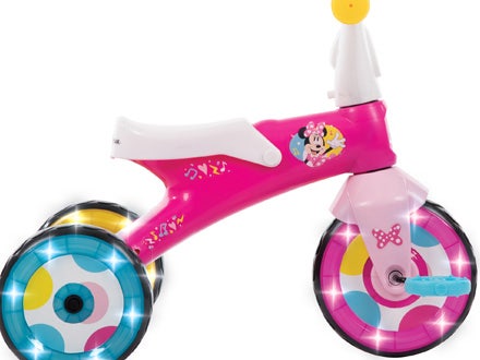 Side view of a trike with colorful LED wheels glowing brightly. Side view of a trike with colorful LED wheels glowing brightly.