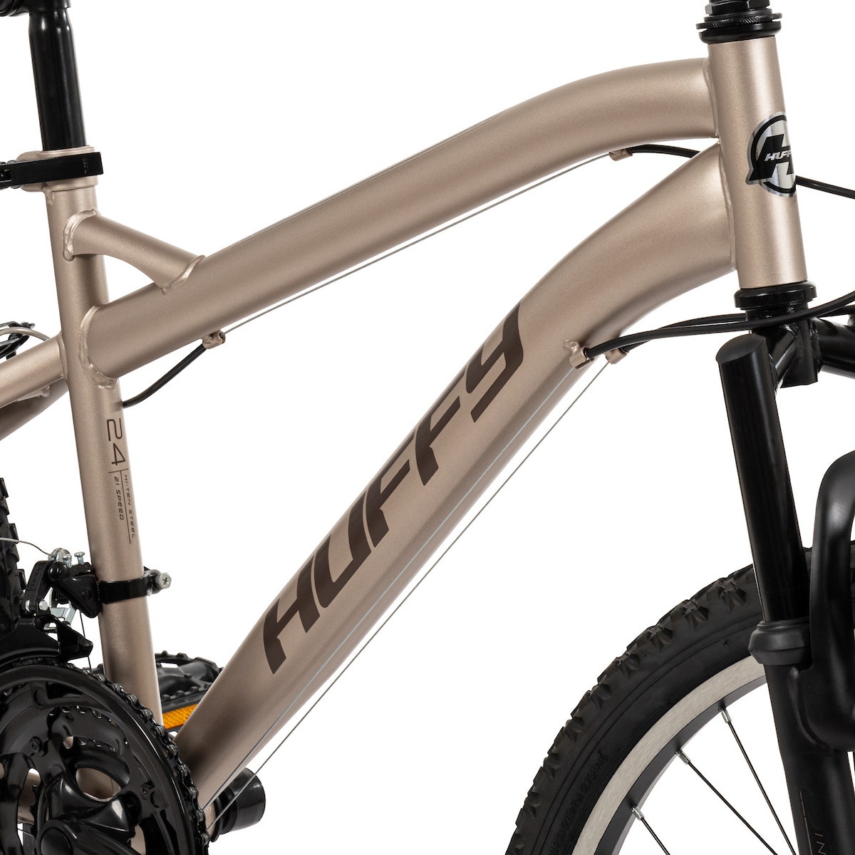 Close-up side view of a tan Huffy mountain bike frame showing the Huffy logo and frame geometry. Close-up side view of a tan Huffy mountain bike frame showing the Huffy logo and frame geometry.