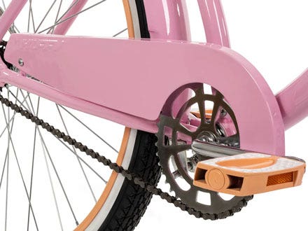 Close-up of a pink cruiser bike chain guard, designed to protect the chain and prevent clothing from getting caught. Close-up of a pink cruiser bike chain guard, designed to protect the chain and prevent clothing from getting caught.