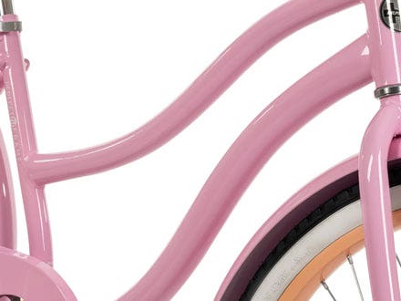 Close-up of a pink cruiser bike frame with a lightweight design and relaxed geometry for a comfortable ride. Close-up of a pink cruiser bike frame with a lightweight design and relaxed geometry for a comfortable ride.
